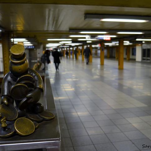Estatuilla de Tom Otterness en el metro de Nueva York.